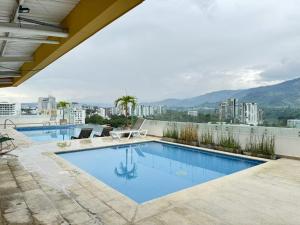 a swimming pool on the roof of a building at Fundadores Apartment with balcony, pool, gym in Armenia