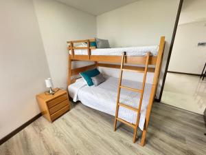 a room with two bunk beds and a ladder at Fundadores Apartment with balcony, pool, gym in Armenia +79 photos