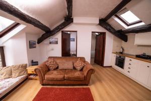 a living room with a couch and a kitchen at The Granary in Bampton
