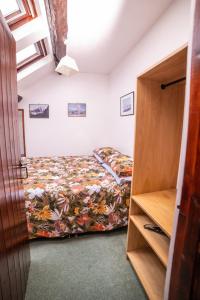 a small bedroom with a bed and a closet at The Granary in Bampton