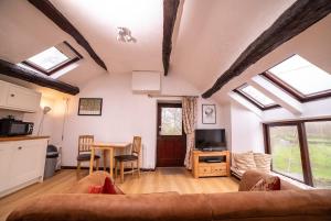 a living room with a couch and a table at The Granary in Bampton