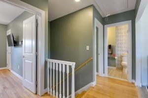 a hallway with a green wall and a stairway at 8 Mi to DC Cheverly Apt with Easy Metro Access in Cheverly +21 photos