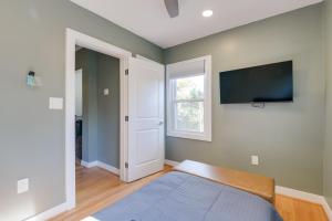 a bedroom with a bed and a flat screen tv at 8 Mi to DC Cheverly Apt with Easy Metro Access in Cheverly