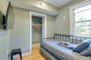 a bedroom with a bed and a window at Walk to Metro Station! Cheverly Apt 8 Mi to DC in Cheverly