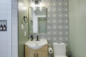 a bathroom with a sink and a mirror and a toilet at Walk to Metro Station! Cheverly Apt 8 Mi to DC in Cheverly +18 photos