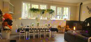 a dining room with a table with chairs and balloons at Domek Pod Grzybkiem in Dźwierszno Małe