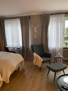 a bedroom with a bed and a chair and a table at Casa Soden, Artful living close to Frankfurt in Bad Soden am Taunus