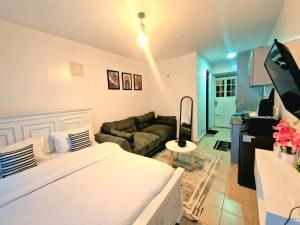 a living room with a bed and a couch at The Velvet Studio - Urban Escape in Ruaka