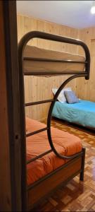 a couple of bunk beds in a room at Aves & árboles Casa 7p piscina y fogón in El Cerrillo