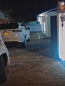 a white car parked next to a building at night at Apache appartement in Paramaribo