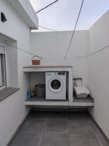 a washing machine sitting on a shelf in a room at Casa el pinar in La Orotava +10 photos