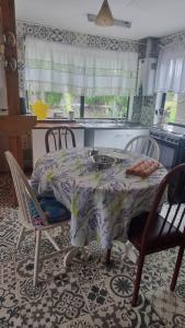 a kitchen with a table with chairs and a table and a table and chairsktop at La mama Pocho in Chile Chico