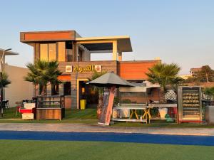 a building with a store with an umbrella in front at Auberge Complexe Medina Parc in Mahelma