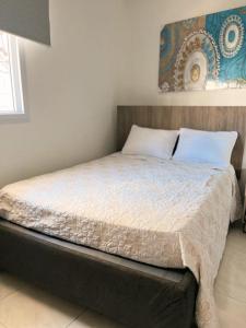 a bed in a bedroom with at ULTIMO DeL SEMANA in San Andrés