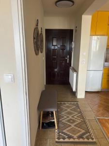 a room with a door and a chair in front of it at Stan na dan Kalin in Bugojno +7 photos