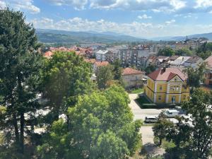 a yellow house in the middle of a city at Stan na dan Kalin in Bugojno