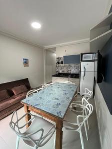 a kitchen with a table and chairs in a room at Miragem de Bombinhas DUO in Bombinhas