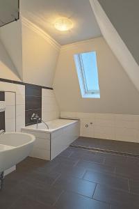 a bathroom with a sink and a bath tub at Großes Ferienhaus in Siegen-Kreuztal auch für Monteure in Kreuztal