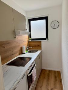 a small kitchen with a sink and a window at Grüne Oase in Stadtnähe in Unna