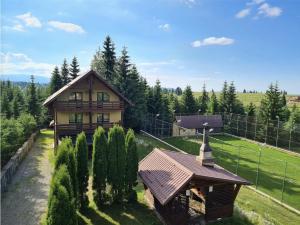 an aerial view of a house with a church at Zori de Zi & Apus de Soare in Bălceşti