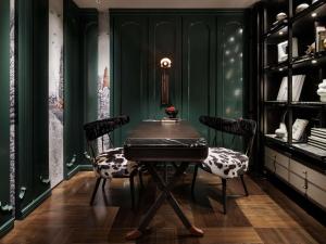 a dining room with a table and chairs and green walls at Hotel Sosei Sapporo MGallery Collection in Sapporo