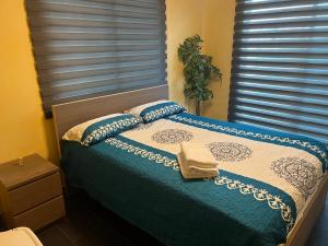 a bedroom with a bed with blue sheets and pillows at Dreamvillage in Boca Chica
