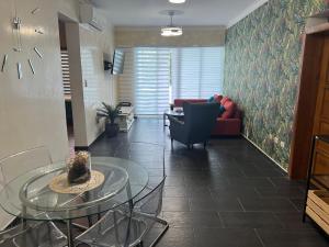 a living room with a glass table and a couch at Dreamvillage in Boca Chica