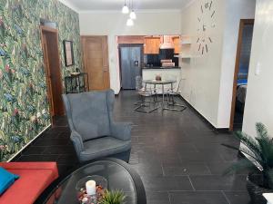 a living room with a chair and a table at Dreamvillage in Boca Chica