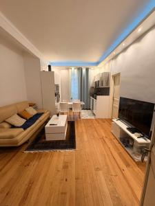 a living room with a couch and a table at Évasion tout confort au T3 bis Pyrénées Palace in La Celle-sous-Gouzon