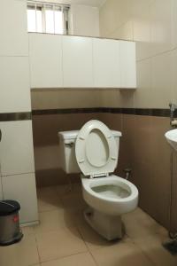 a bathroom with a toilet and a sink at Sea Shell Hotel - Sales & Booking Office in Bāiljuri +46 photos
