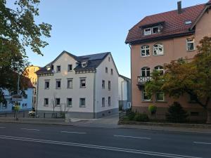 two white buildings on the side of a street at Ravensburg City Apartment in Ravensburg