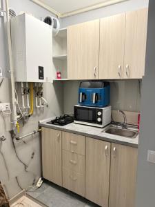 a kitchen with a microwave and a sink at InnTimee in Turda +11 photos