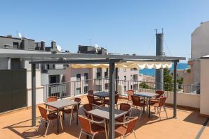 a patio with tables and chairs on a balcony at DBV Guesthouse in Lagos