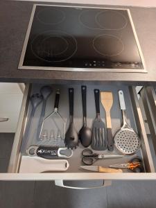 a drawer filled with cooking utensils in a kitchen at Ravensburg City Apartment in Ravensburg