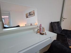 a white counter with two chairs and a mirror at Ravensburg City Apartment in Ravensburg +95 photos