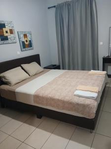 a bed with two towels on it in a bedroom at Marina in Paralia Katerinis