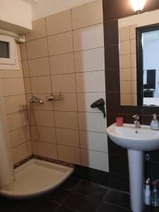 a bathroom with a sink and a shower at Marina in Paralia Katerinis