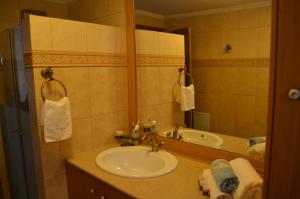 a bathroom with a sink and a mirror at Villa Blu Majestic beach villa in Halki