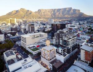 an aerial view of a city with mountains in the background at The Lookout in Cape Town