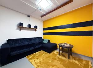 a living room with a couch and a table at Bienenhaus in Troisdorf +14 photos