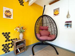 a hanging chair with red pillows in a room at Bienenhaus in Troisdorf