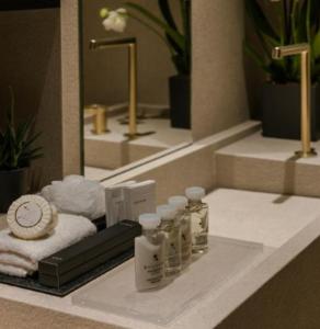 a bathroom with a sink with towels and a mirror at agistri hosting in Megalochori
