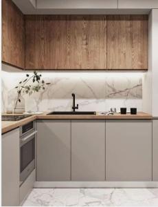 a kitchen with white cabinets and a sink at agistri hosting in Megalochori