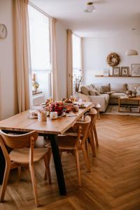 a living room with a wooden table and chairs at JUGA Apartmány in Jaroslavice