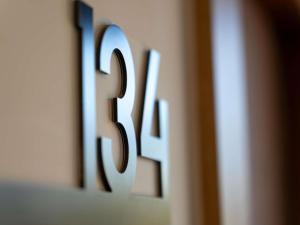 a close up of a wooden number on a wall at ibis Styles Cabriès Aix-en-Provence TGV in Cabriès +70 photos
