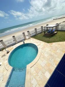 a swimming pool with the beach in the background at Recanto do Amor in Cascavel +64 photos