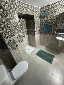a bathroom with a toilet and a sink at Dar Ben Othman in Tozeur +8 photos