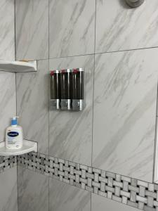 a bathroom with a shower with white marble tiles at Minutes to Beach, Mayo Clinic, Hot Tub, King Bed, Free PPV in Jacksonville