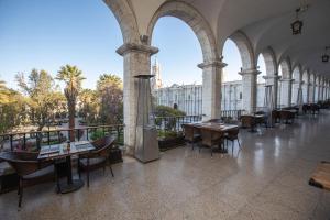 a restaurant with tables and chairs in a building at Casa Andina Select Arequipa Plaza in Arequipa