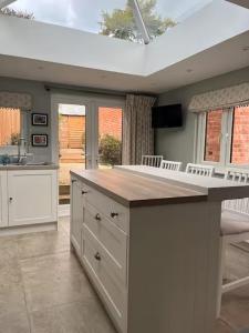a kitchen with a large island with a counter top at Charming cottage in Urchfont